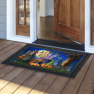 Black doormat with Halloween design, Witches Brew Doormat on wooden porch outside open door.