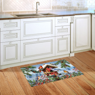 Winter Birdhouse Gathering Doormat on hardwood floor beside kitchen sink and white cabinets.