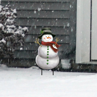 Smiling Snowman Metal Art in snowy yard with hat, red scarf, and green buttons on stand.