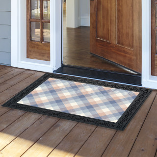 Pink and blue check doormat with black border on wooden porch in front of doorway.