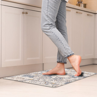 Vintage Patchwork Comfort Mat in blue and white on kitchen floor under bare feet.