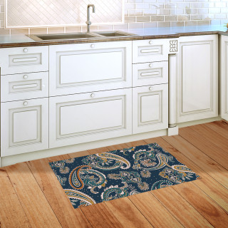 Blue Paisley Doormat on wooden kitchen floor beside white cabinets and sink.