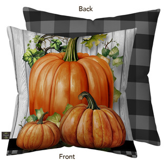 Country Farmhouse Pumpkins Burlap Pillow with orange pumpkins and green leaves on white wood background.