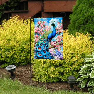 Fancy Peacock Garden Flag with colorful peacock and flowers on a garden stand outdoors.