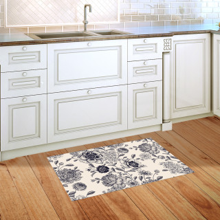 Woodcut Floral Doormat with white background and blue floral pattern on wooden kitchen floor.