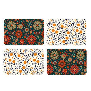 Four colorful floral placemats, Dining in Style brand, 4-pack, with orange, white, and green designs.