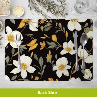 Black floral placemat with white flowers and silverware on a table setting, Bold Florals design.