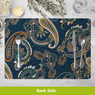 Bold Patterns Placemat with navy blue background and orange, green, and white paisley designs, silverware on top.