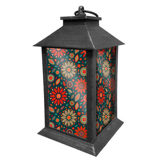 Black metal lantern with orange, teal, and beige floral pattern on sides, pyramid roof handle.
