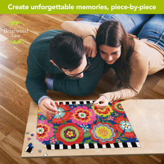 Couple working on Bright Blooms 1000 piece jigsaw puzzle with colorful floral design on wooden table.
