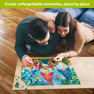 Couple working on Briarwood Lane Gnome Sweet Gnome Spring 1000 piece jigsaw puzzle together on floor.