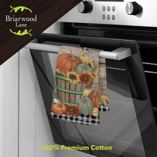 Bountiful Bushel Cotton Hand Towel with pumpkin and sunflower design hanging on oven handle.