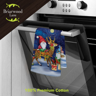 Happy Holiday Gnomes cotton hand towel hanging on oven handle, Briarwood Lane brand, festive holiday design.