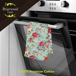 Spring Floral Cotton Hand Towel, blue background with pink roses and green leaves, hanging on oven handle.
