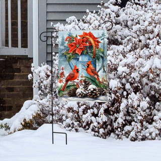 Winter Watering Can Garden Flag with cardinals, poinsettias on snowy bush outside house with gray siding.