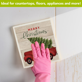 Merry Christmas Pickup Swedish Dishcloth, red truck, green tree on beige background with pink glove.