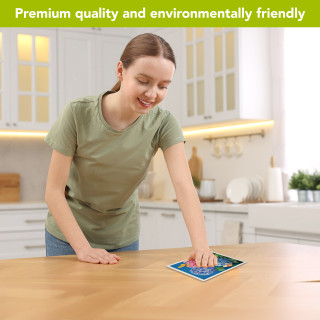 Woman wiping table with Colorful Hydrangeas Swedish Dishcloth in a modern kitchen setting.