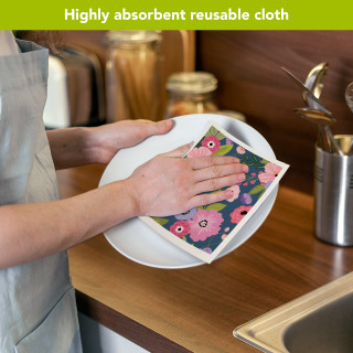 Happy Blooms Swedish Dishcloth with pink floral design being used to dry a white plate.
