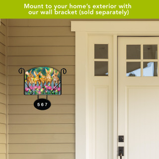 Garden Bunnies Spring Acrylic Art Sign with colorful bunnies, flowers on beige house exterior wall bracket.