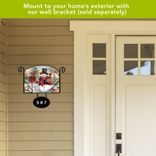 Snowman and Friends Acrylic Art Sign mounted on a house exterior wall beside a door.