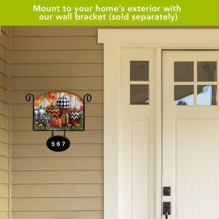 Patterned Pumpkins Acrylic Art Sign with colorful pumpkins and floral design on a house exterior wall.