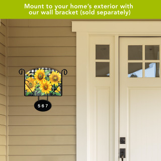 Checkered sunflowers acrylic art sign with house number 567 in black metal bracket outdoors.