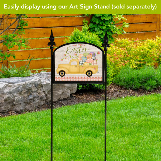 Easter Egg Pickup Acrylic Art Sign on stand with yellow truck and colorful eggs outdoors.