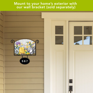 Lemonade themed acrylic art sign with colorful floral design and house number 567 on beige siding.