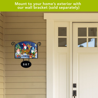Happy Holiday Gnomes acrylic art sign with gnomes and festive design on a house exterior wall.