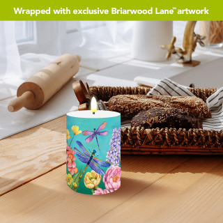 Dragonfly Garden Flameless Candle, colorful dragonfly design on teal background, cylindrical shape, lit flame.