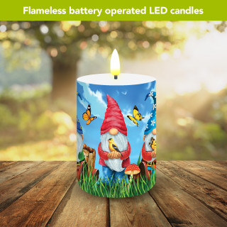 Gnome Sweet Gnome flameless LED candle with colorful gnome, butterfly, and mushroom design on wooden table.