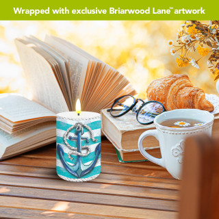 Welcome Anchor Flameless Candle with nautical design on a wooden table with breakfast items nearby.