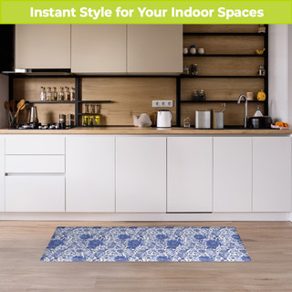 Blue and white oversized floral comfort mat on a wooden floor in a modern kitchen setting.