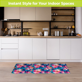 Vibrant abstract floral oversized comfort mat in pink, blue, and white on a kitchen floor.