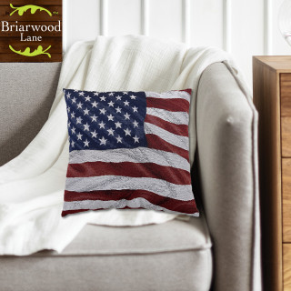 American Flag Waving Indoor Pillow on a beige chair with white throw blanket, red, white, blue.