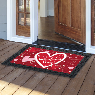 Red Heart Toss doormat with white and pink hearts and Happy Valentine's Day text on wooden porch.