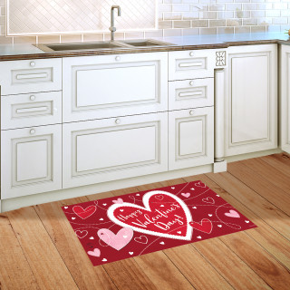 Red Heart Toss Doormat with white and pink hearts on wooden kitchen floor beside sink.