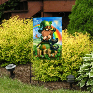 Lucky Irish Gnome Garden Flag with green hat and rainbow on a garden stand outdoors.