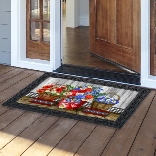 Red White and Beautiful doormat with floral design on wooden porch outside open door.