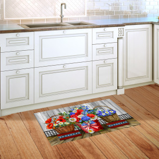 Red White and Beautiful floral doormat on wooden kitchen floor beside white cabinets and sink.