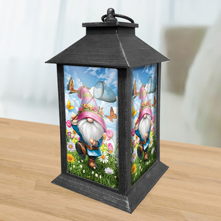 Black metal Springtime Gnome Lantern with colorful gnome, flowers, and butterflies design on glass panels.
