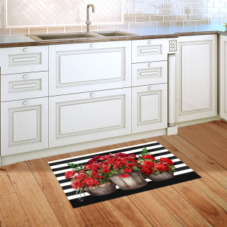 Striped Geraniums doormat on wooden floor in front of white kitchen sink and cabinets.