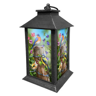 Black metal Fence Post Birds Lantern with colorful bird and floral design on glass panels.