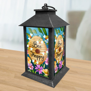 Black metal Happy Beehive Lantern with colorful floral design and "Bee Happy" text on sides.