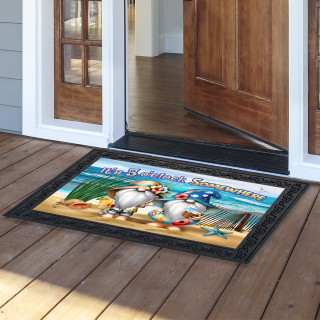 Black doormat with beach gnomes and "5 O'clock Somewhere" text on wooden porch.