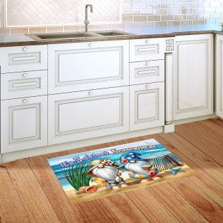 5 O'clock Beach Gnomes colorful doormat on wooden kitchen floor by white cabinets and sink.
