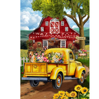 Yellow vintage truck loaded with flowers in front of a rustic red barn house flag design.