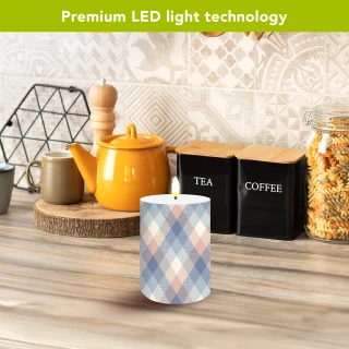 Pink and blue check flameless candle with LED light on wooden countertop beside tea and coffee.