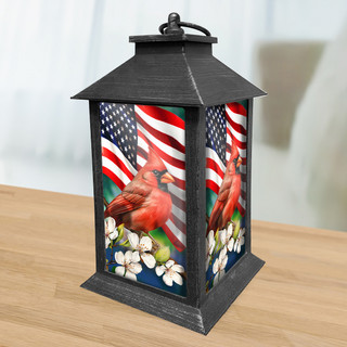 American Cardinal Lantern, black metal, red cardinal, American flag, and white flowers design.
