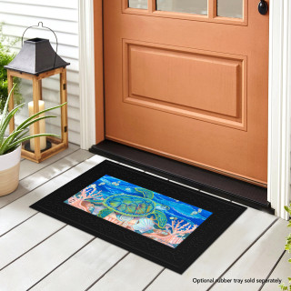 Black mini doormat with colorful swimming sea turtle design on front porch by brown door.